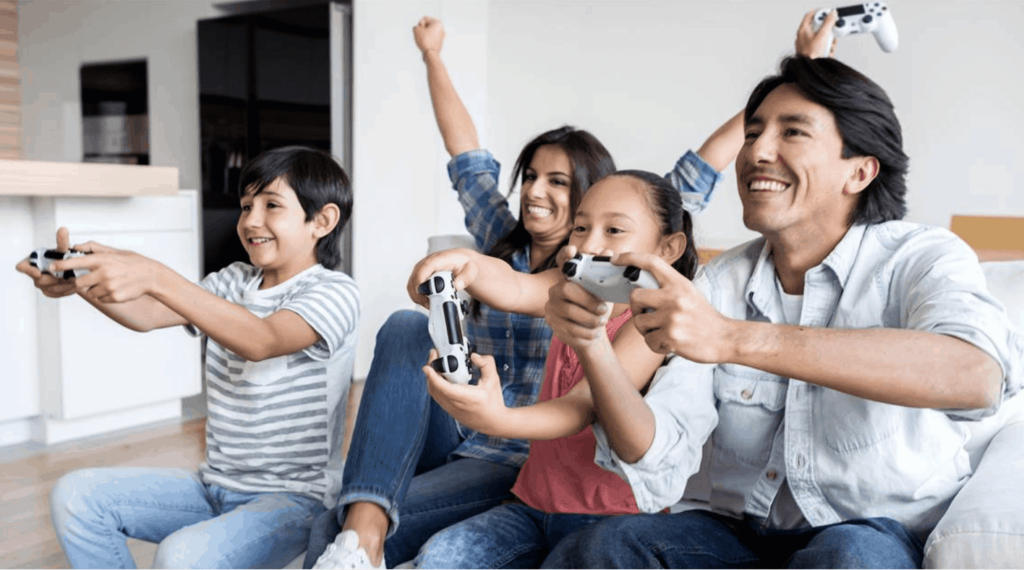Family of 4 playing a video game holding controllers
